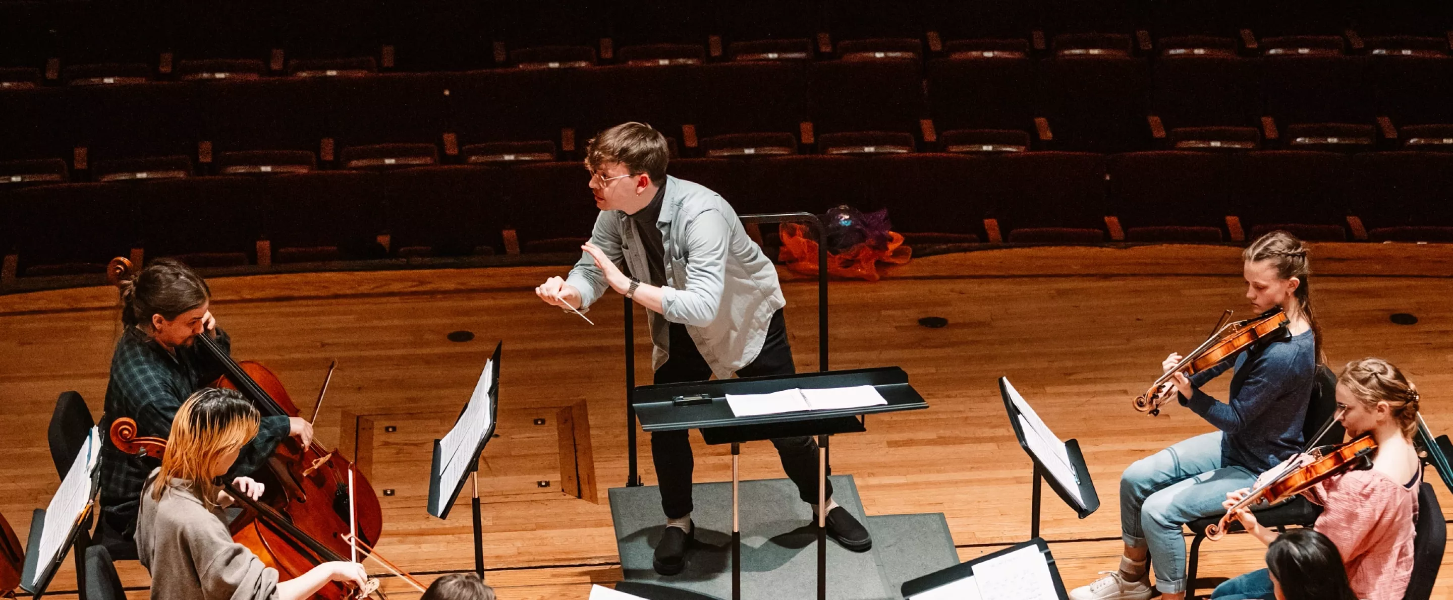Music conductor with orchestra