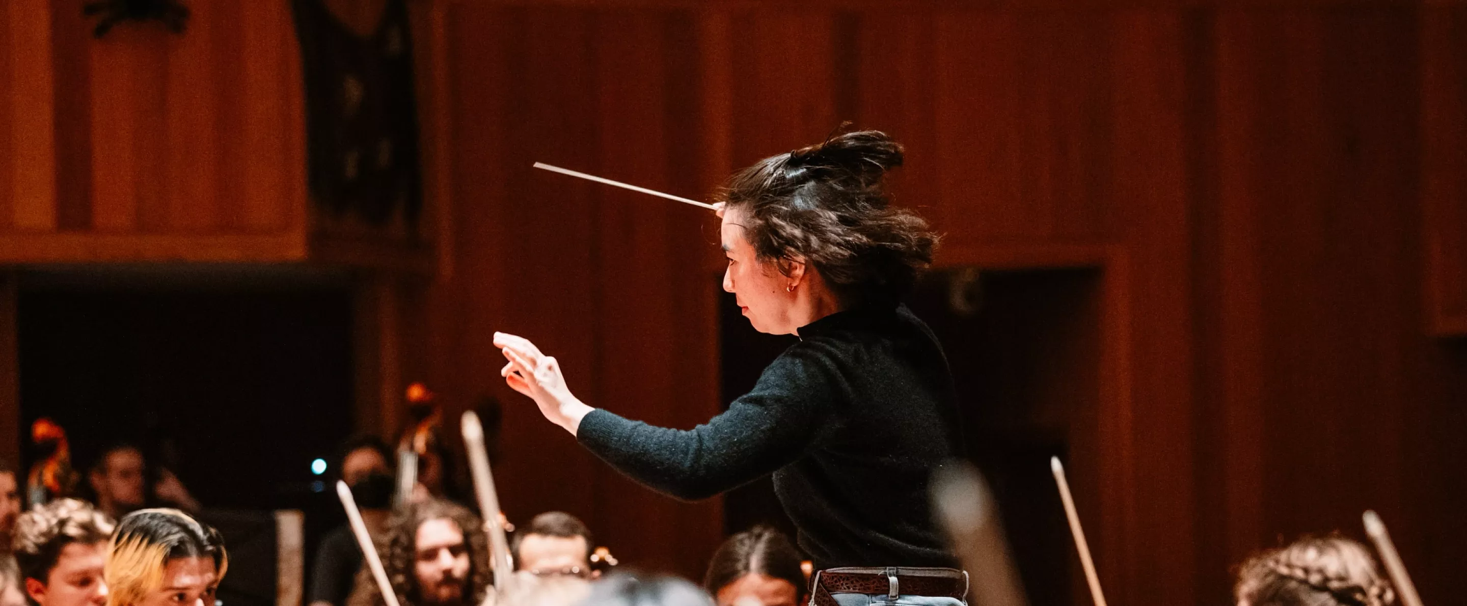 Music conductor with orchestra
