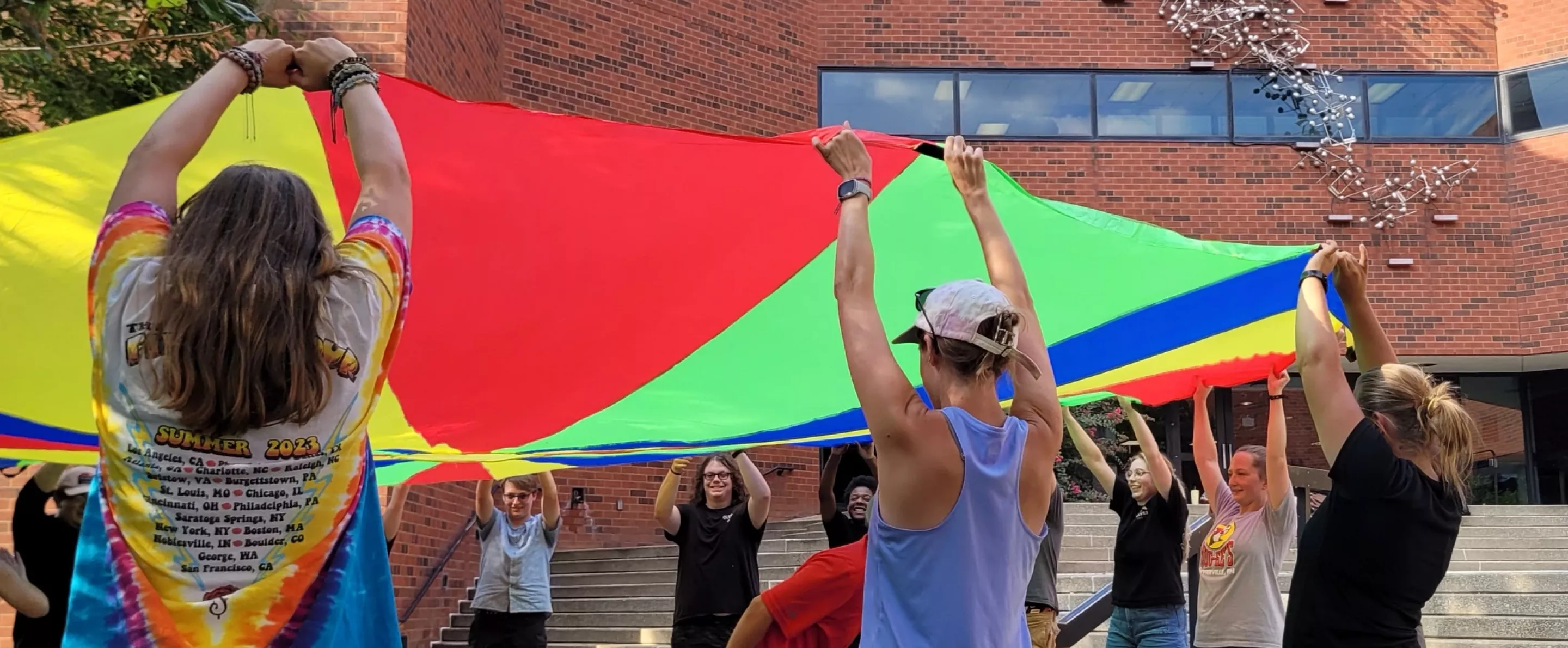 Students learning by playing outside the School of Music