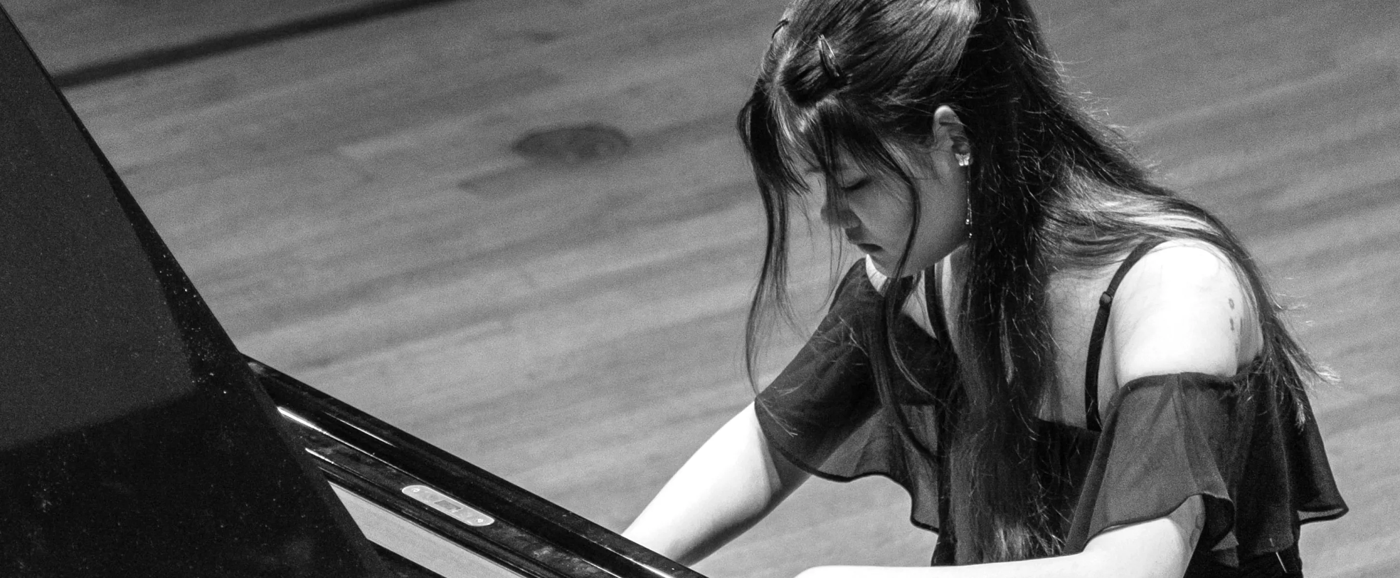 Piano student playing on stage
