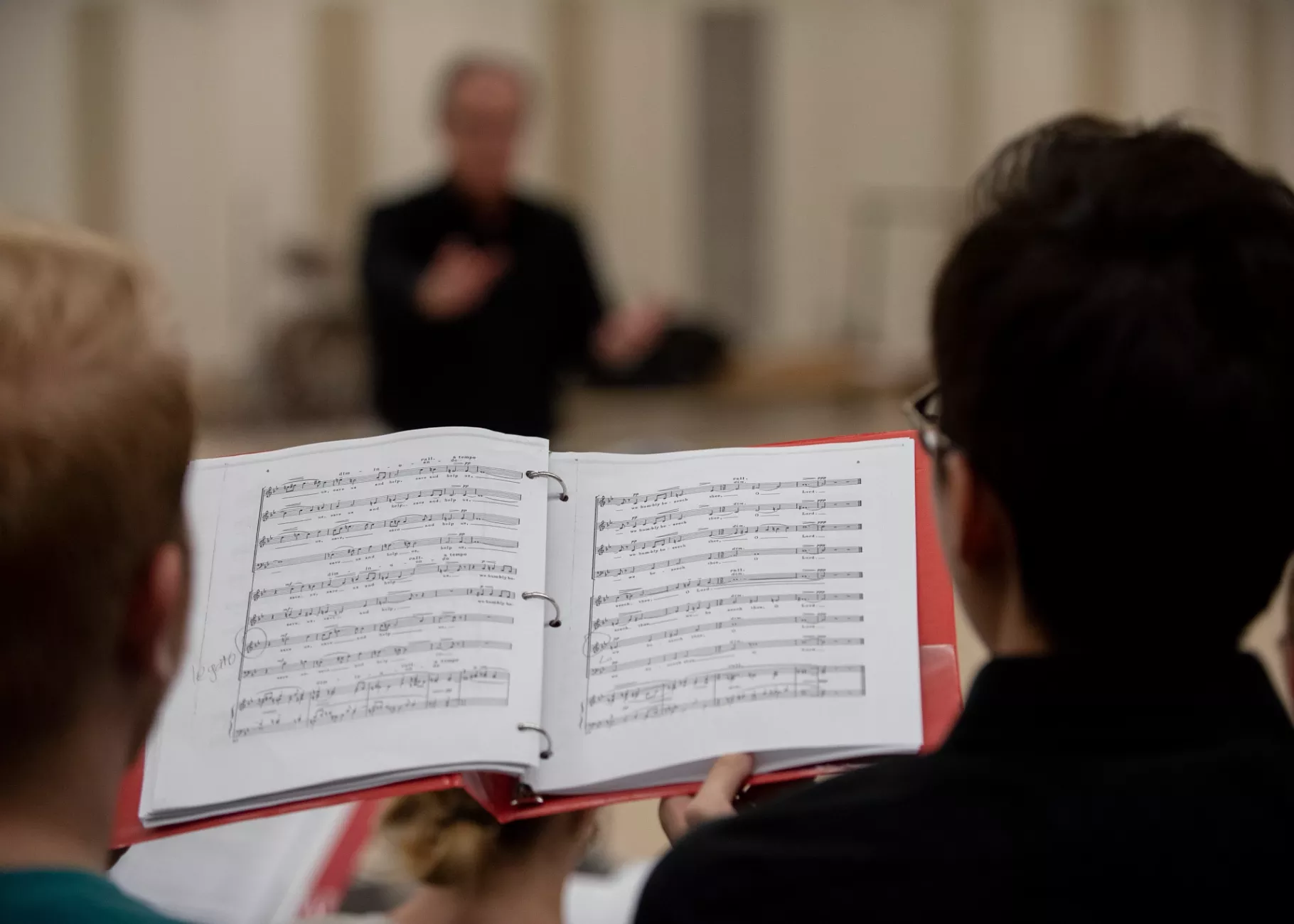 Close-up of sheet music being sung by students in Cardinal Singers