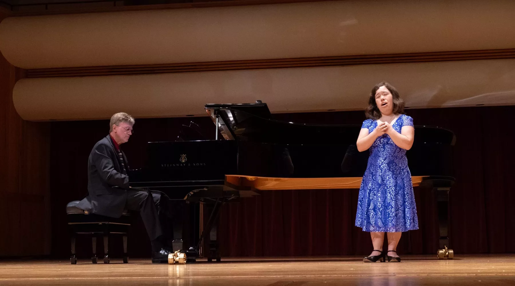 Students singing and playing piano