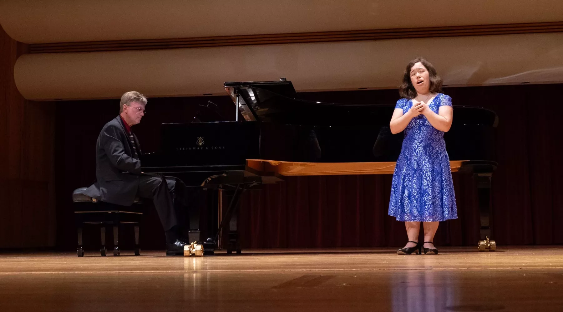 Students singing and playing piano