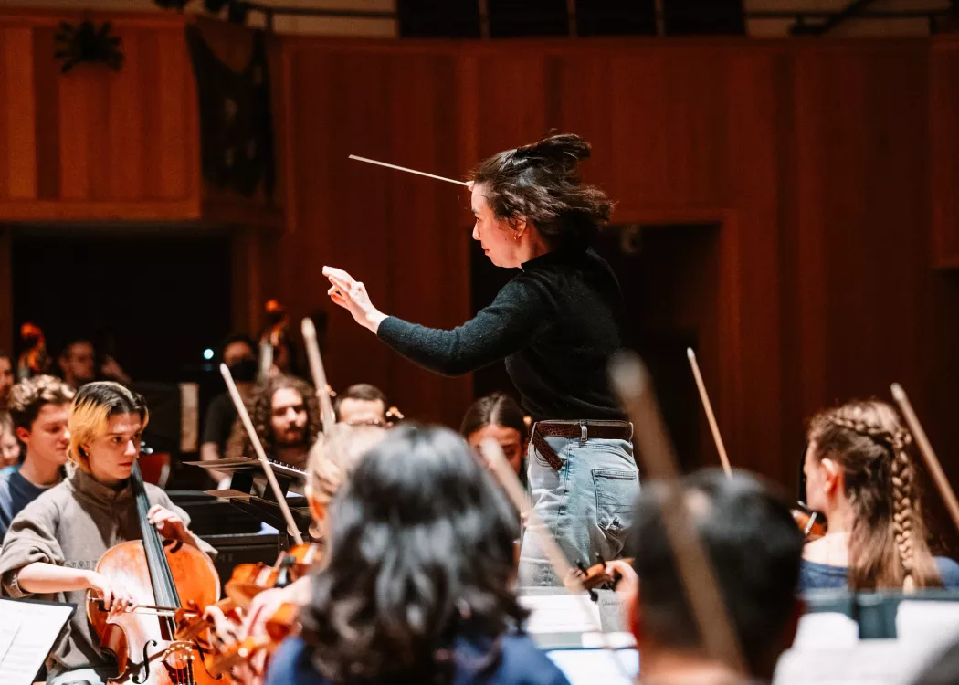 Music conductor with orchestra