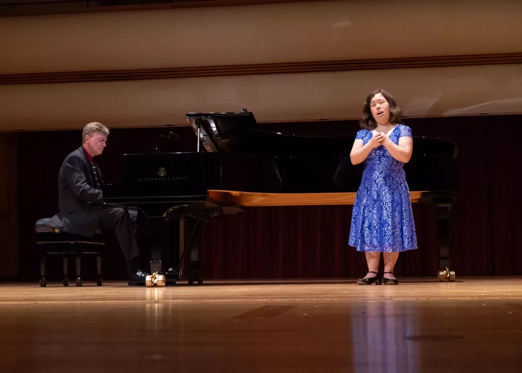 Students singing and playing piano
