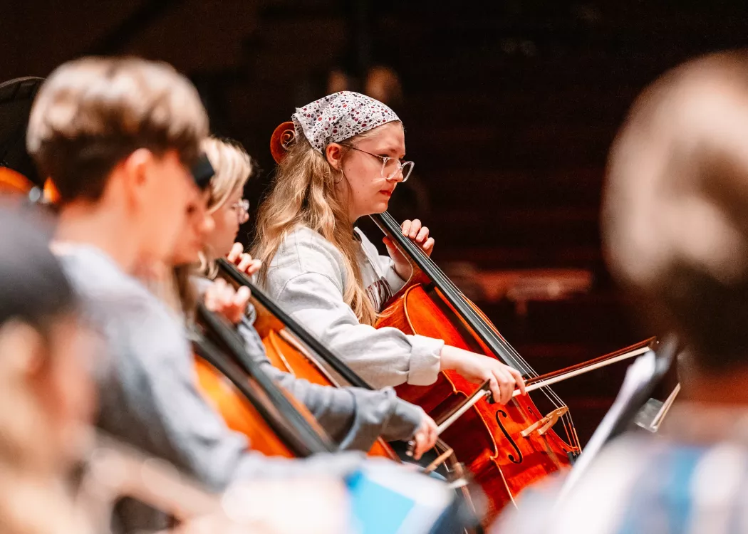Student playing cello at Symphony Orchestra concert