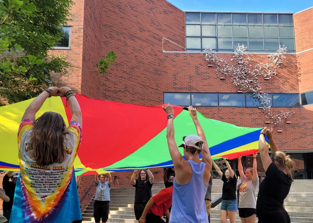 Students learning by playing outside the School of Music
