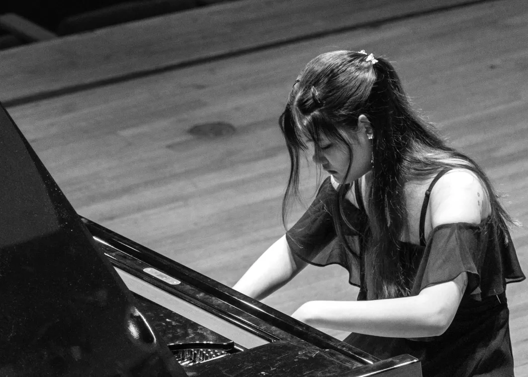 Piano student playing on stage